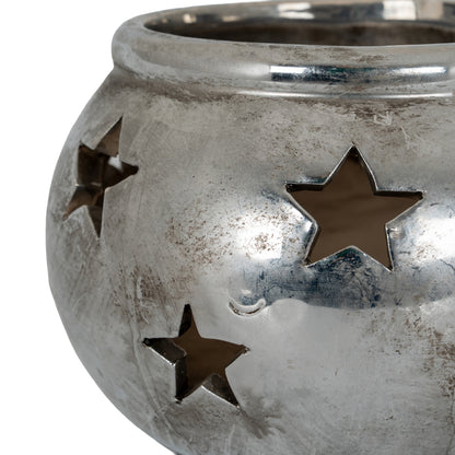 Aspen star tea light lantern shown lit on a table