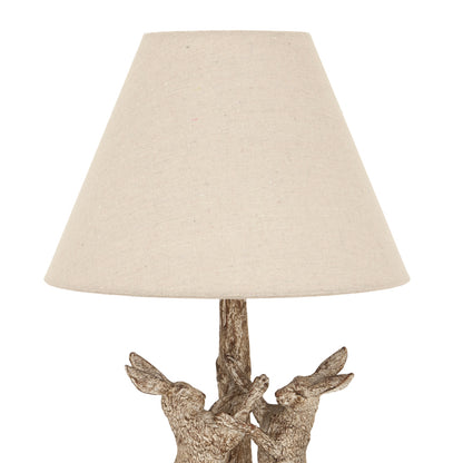 Stonewashed marching hares lamp styled on a shelf