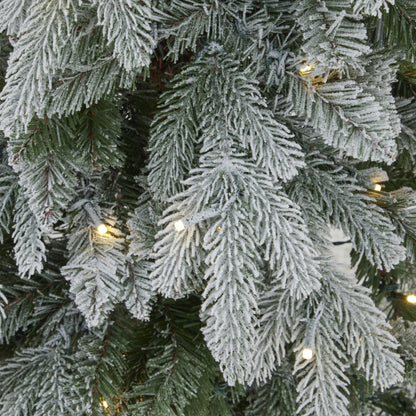 Slim snowy woodland pre-lit Christmas tree shown lit