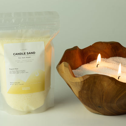 Spirited candle sand: pouch shown beside a lit wooden bowl candle