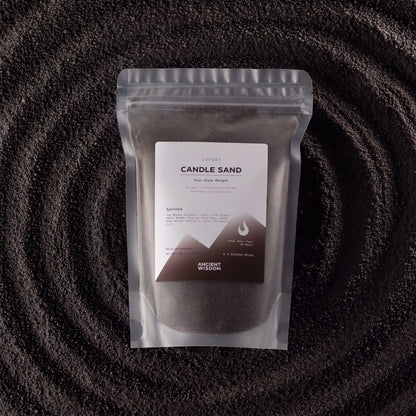 Spirited fragranced candle sand in black, 300g, in a resealable pouch on swirled sand