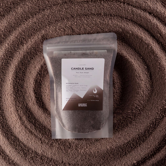 Millionaire Gold fragranced candle sand in chocolate brown, 300g, in a resealable pouch on swirled sand