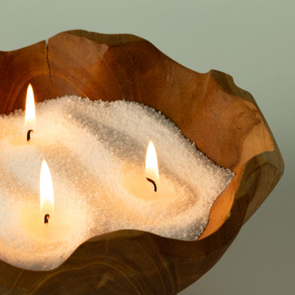 Spirited candle sand: close detail of lit wicks glowing in the sand