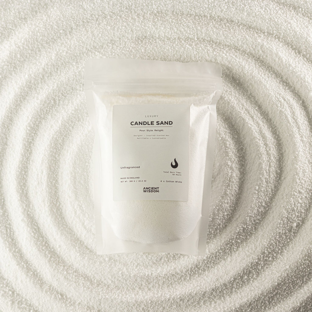 Unfragranced candle sand in white, 300g, in a resealable pouch on swirled sand