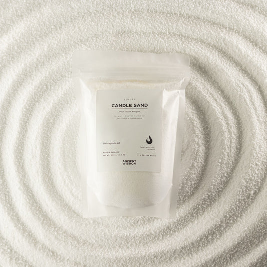 Unfragranced candle sand in white, 300g, in a resealable pouch on swirled sand
