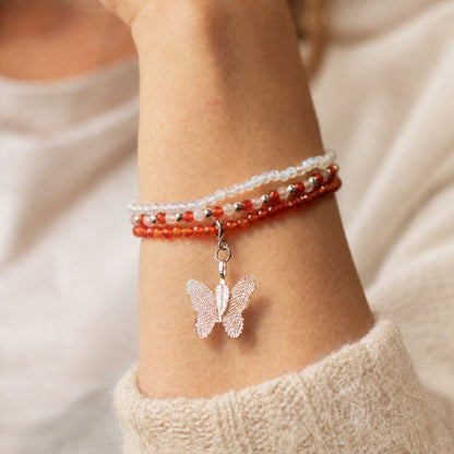 Blood Moon gemstone bracelet set worn as a layered stack on the wrist