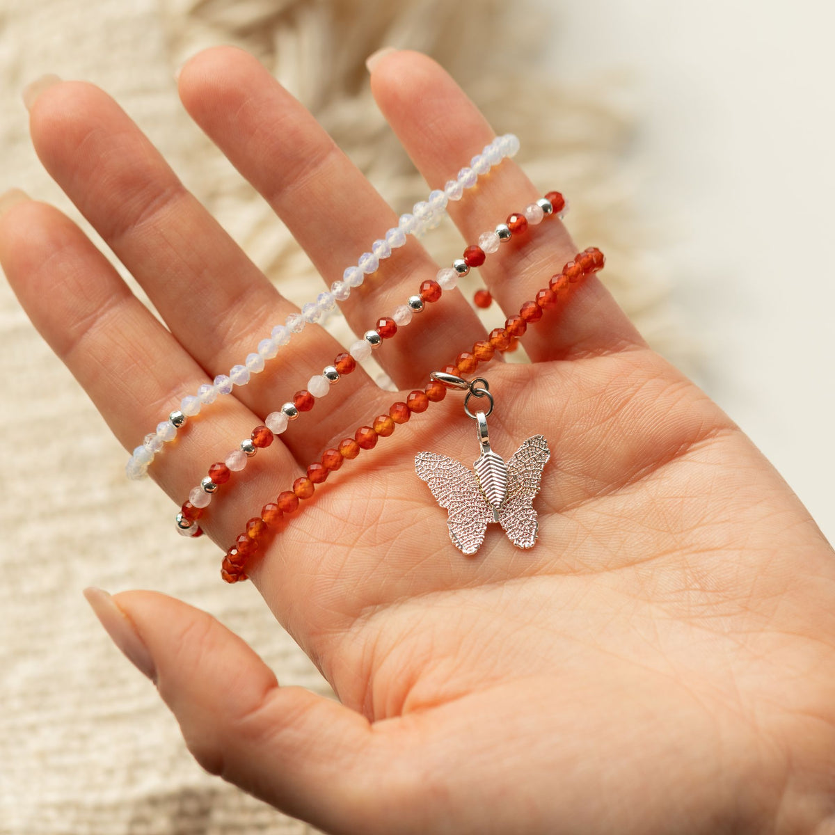 Blood Moon three-bracelet set held in an open palm