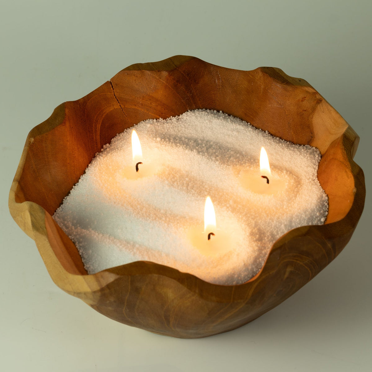 Unfragranced candle sand: styled lit with three wicks in a carved wooden bowl