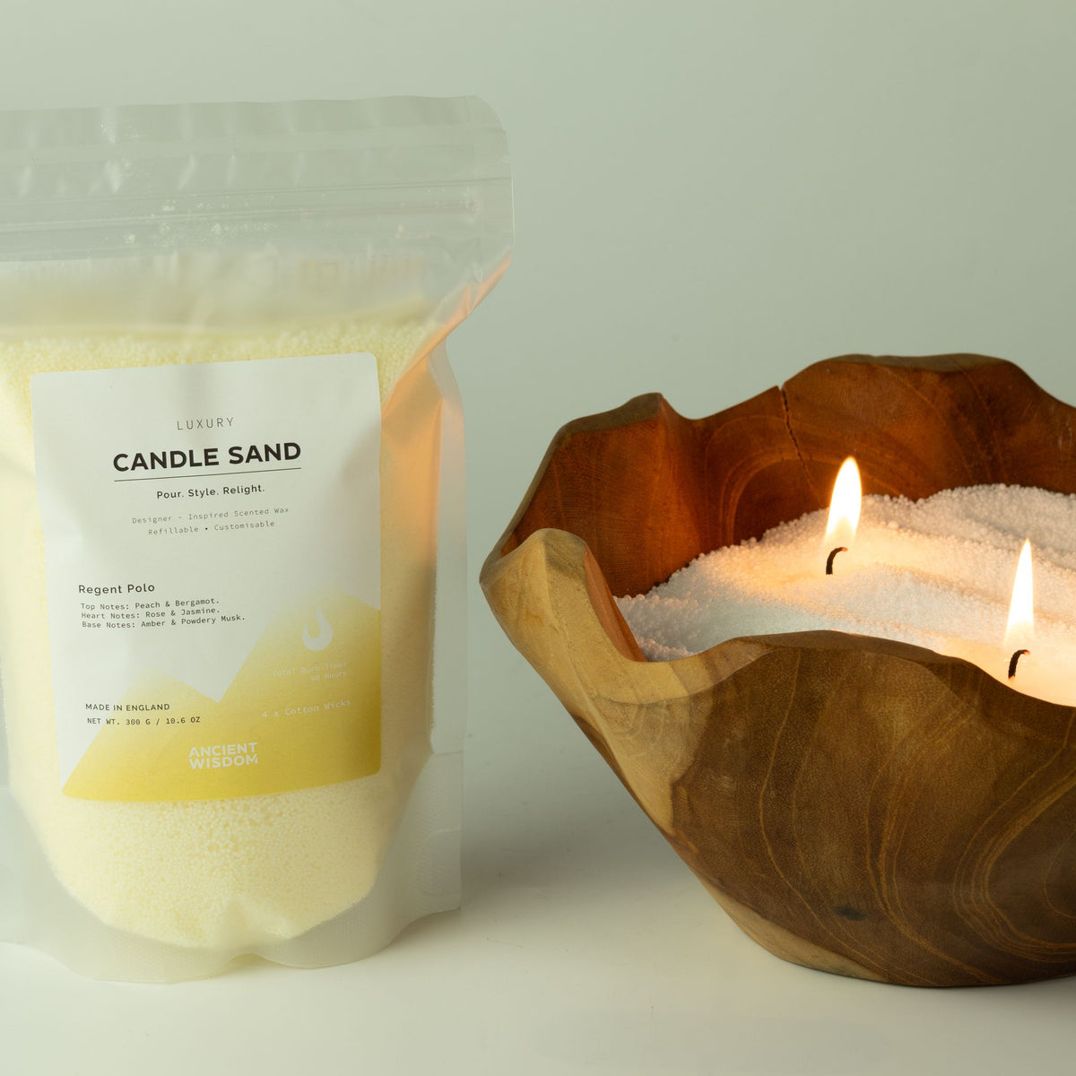 Unfragranced candle sand: pouch shown beside a lit wooden bowl candle