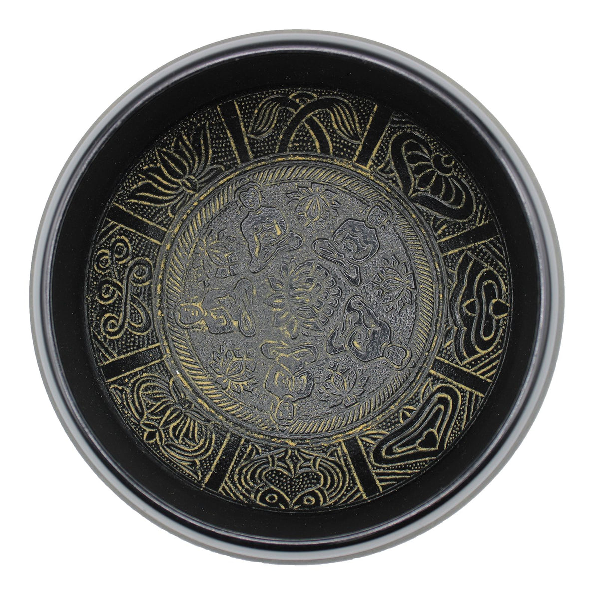 Top view of the five Buddhas engraved inside the singing bowl